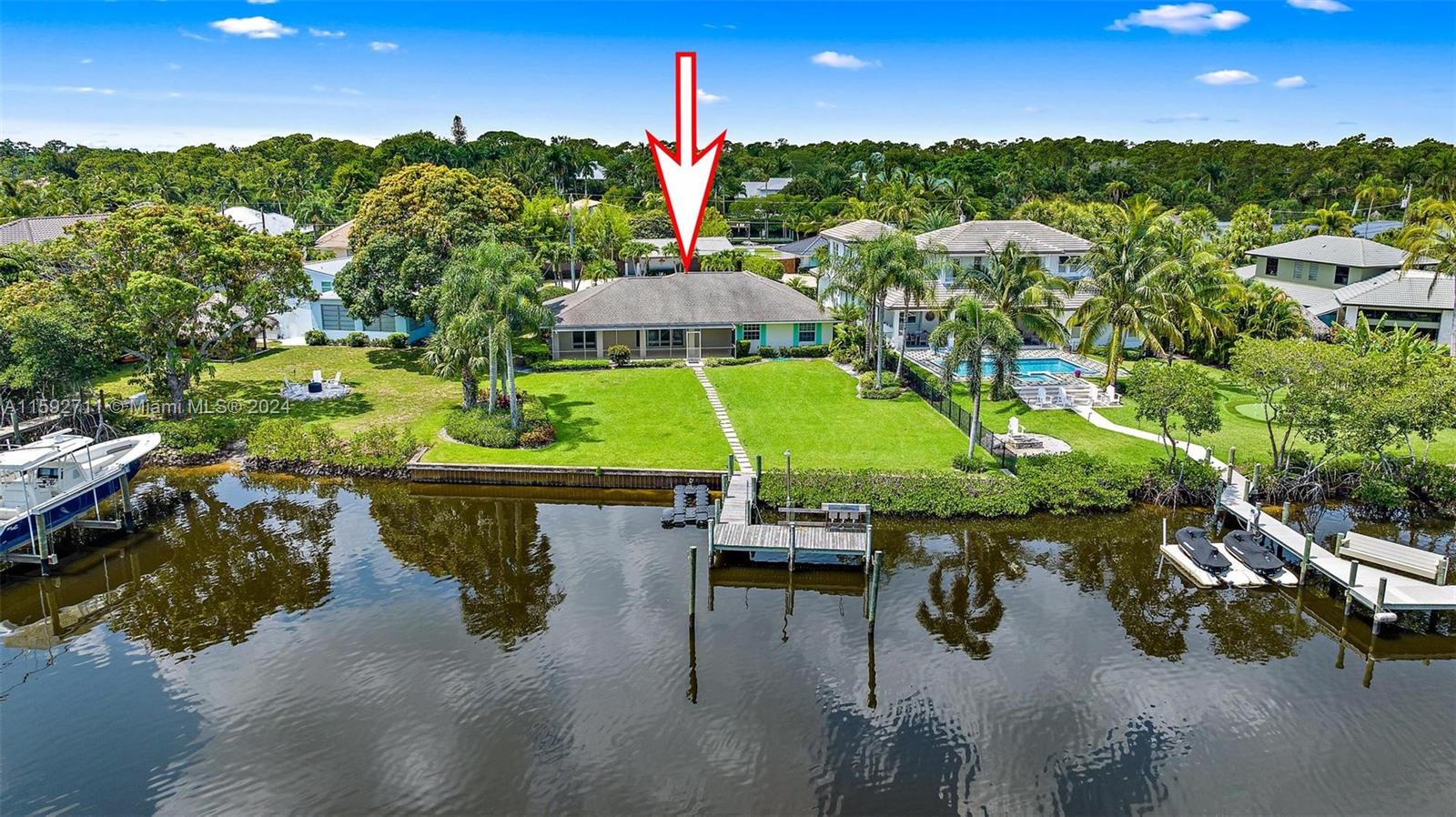 8547 Southeast Merritt Way Jupiter, FL 33458 - Photo 22 of 27 a view of a swimming pool with a yard and potted plants