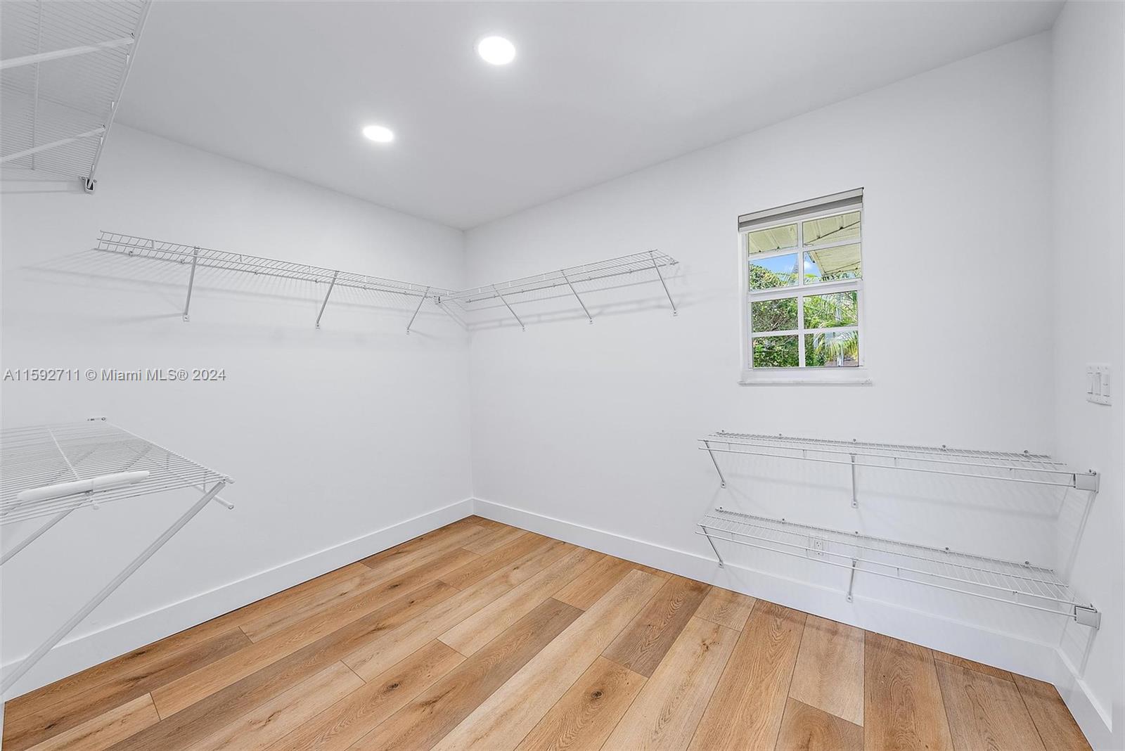 8547 Southeast Merritt Way Jupiter, FL 33458 - Photo 25 of 27 a view of a room with wooden floor and cabinet