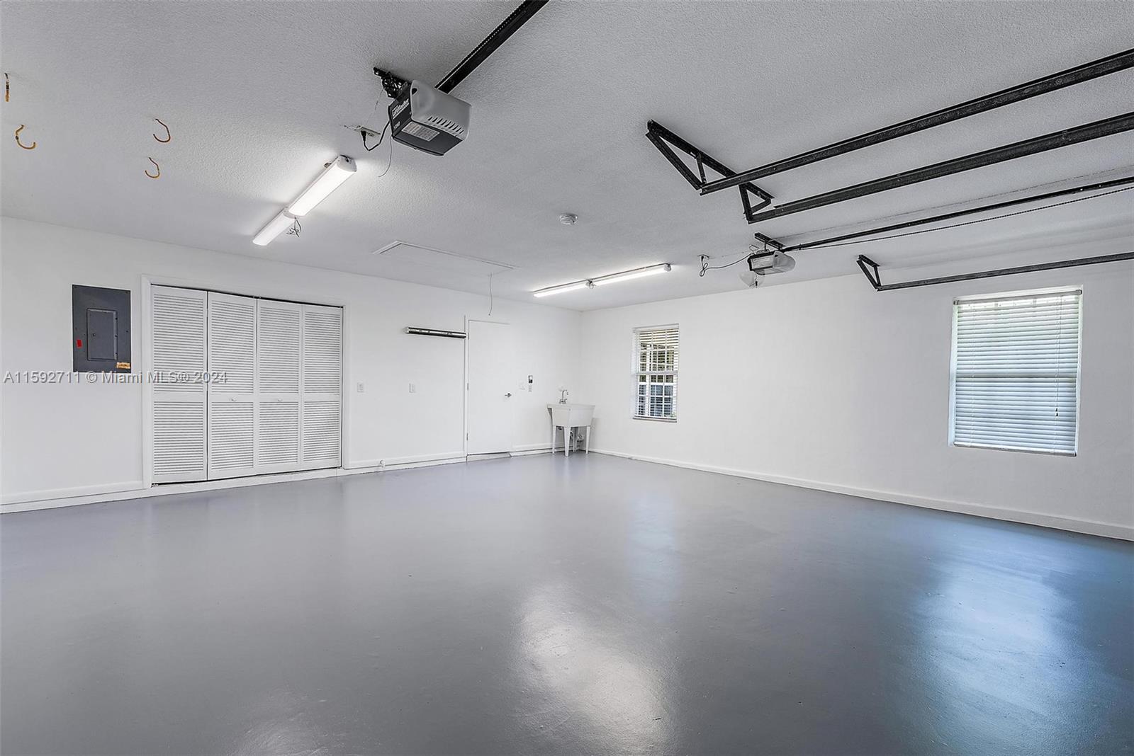 8547 Southeast Merritt Way Jupiter, FL 33458 - Photo 27 of 27 an empty room with wooden floor and windows