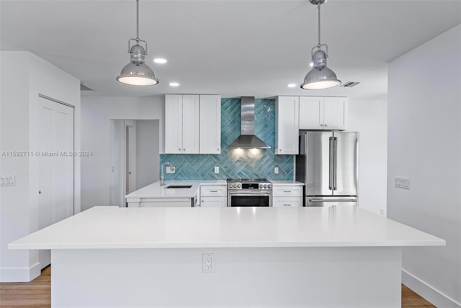 8547 Southeast Merritt Way Jupiter, FL 33458 - Photo 3 of 27 a kitchen with stainless steel appliances granite countertop a sink a refrigerator and a stove