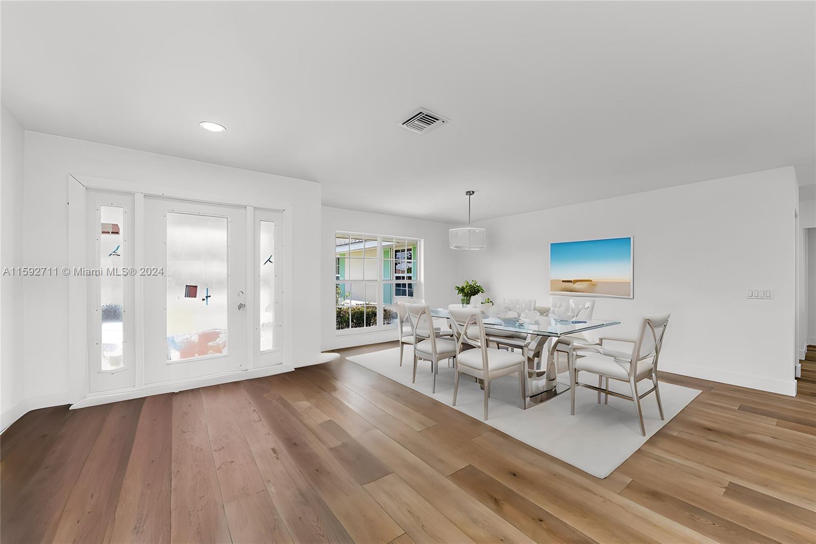 8547 Southeast Merritt Way Jupiter, FL 33458 - Photo 8 of 27 a view of a dining room with furniture and wooden floor