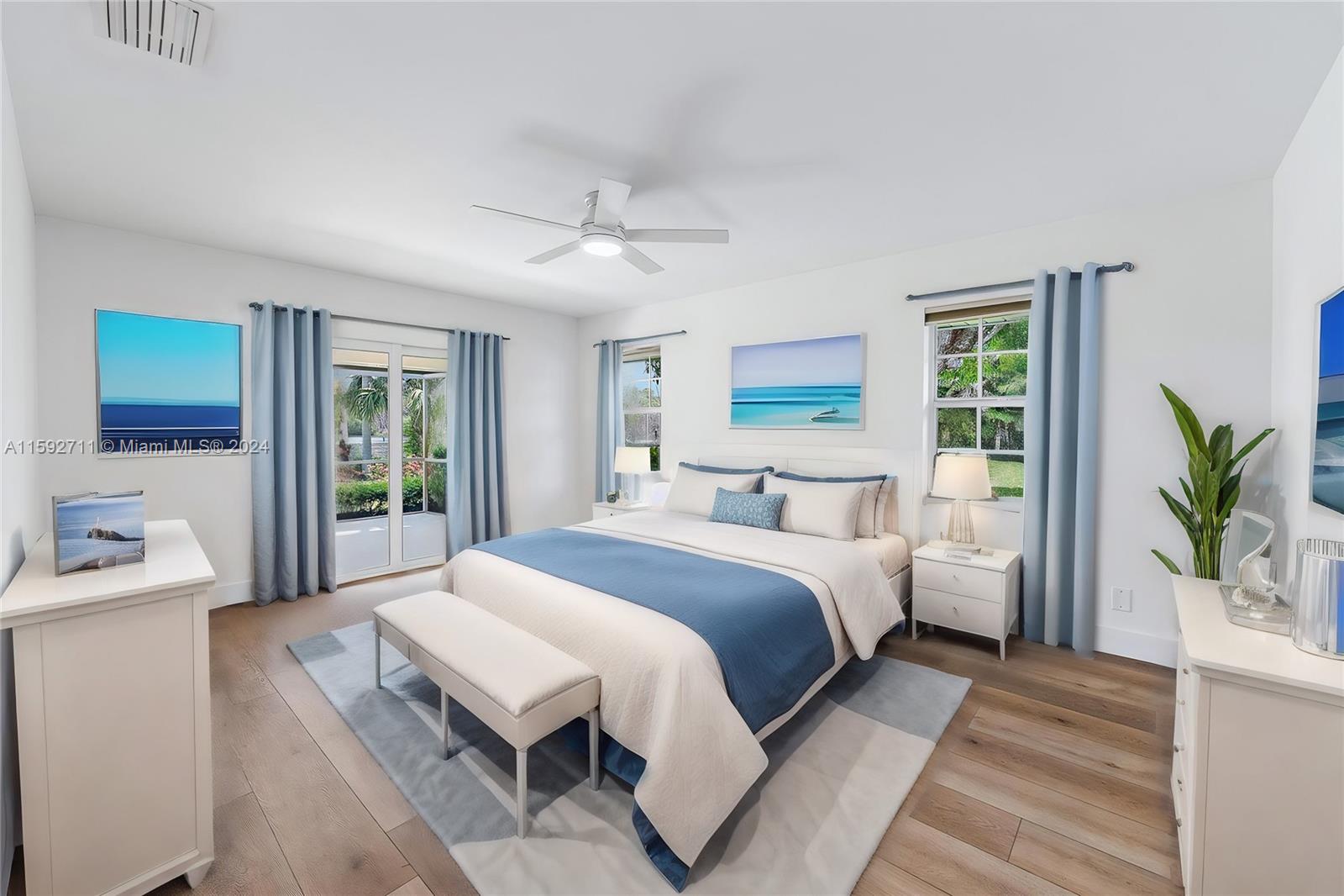 8547 Southeast Merritt Way Jupiter, FL 33458 - Photo 10 of 27 a bedroom with a large bed and a window