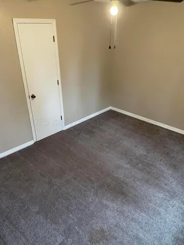 a view of an empty room with a fireplace