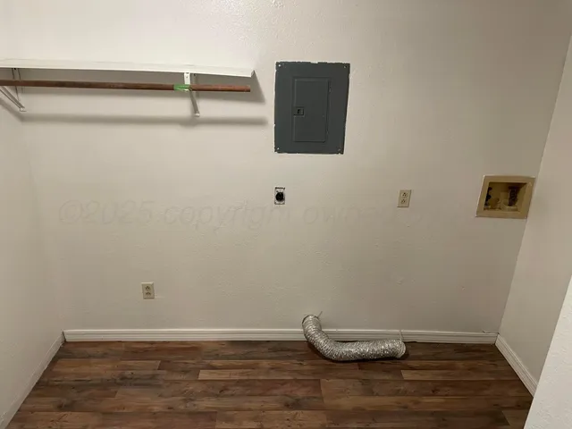 a view of a room with wooden floor