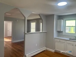 a view of a kitchen with wooden floor and cabinet