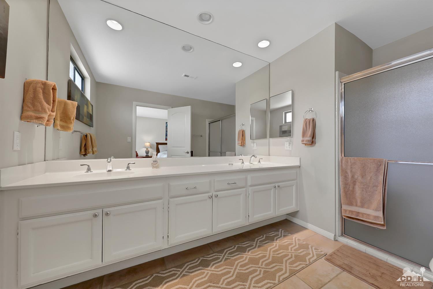 71 Calle Encinitas Rancho Mirage, CA 92270 - Photo 12 of 24 a bathroom with a double vanity sink and mirror