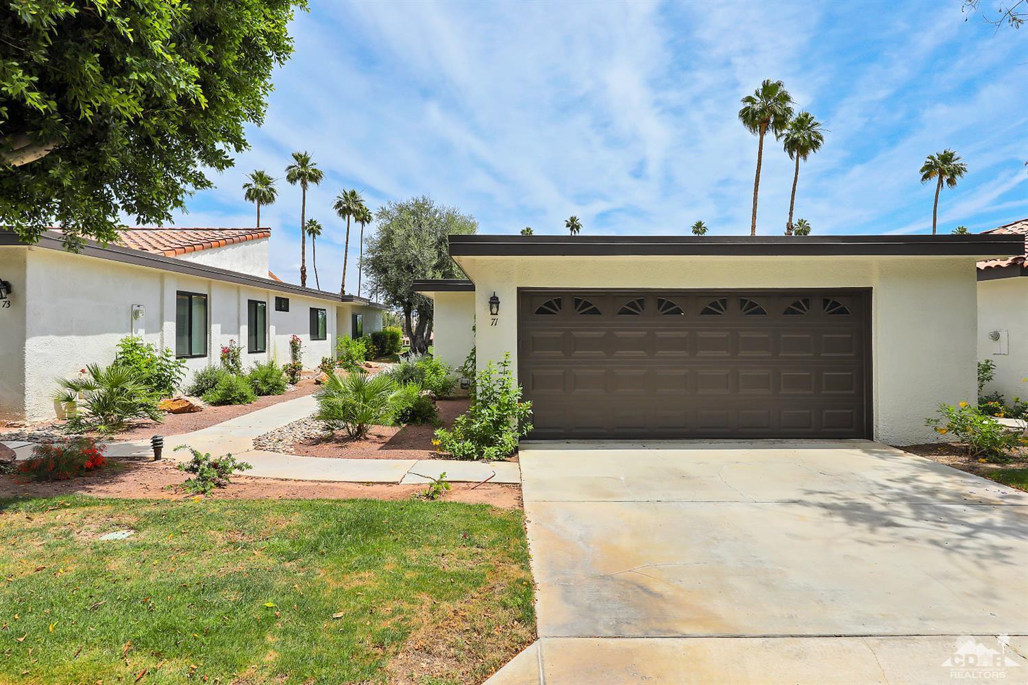 71 Calle Encinitas Rancho Mirage, CA 92270 - Photo 16 of 24 a front view of a house with a yard and garage