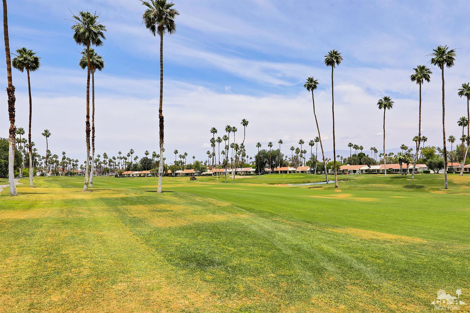 71 Calle Encinitas Rancho Mirage, CA 92270 - Photo 20 of 24 a view of a lake with palm trees