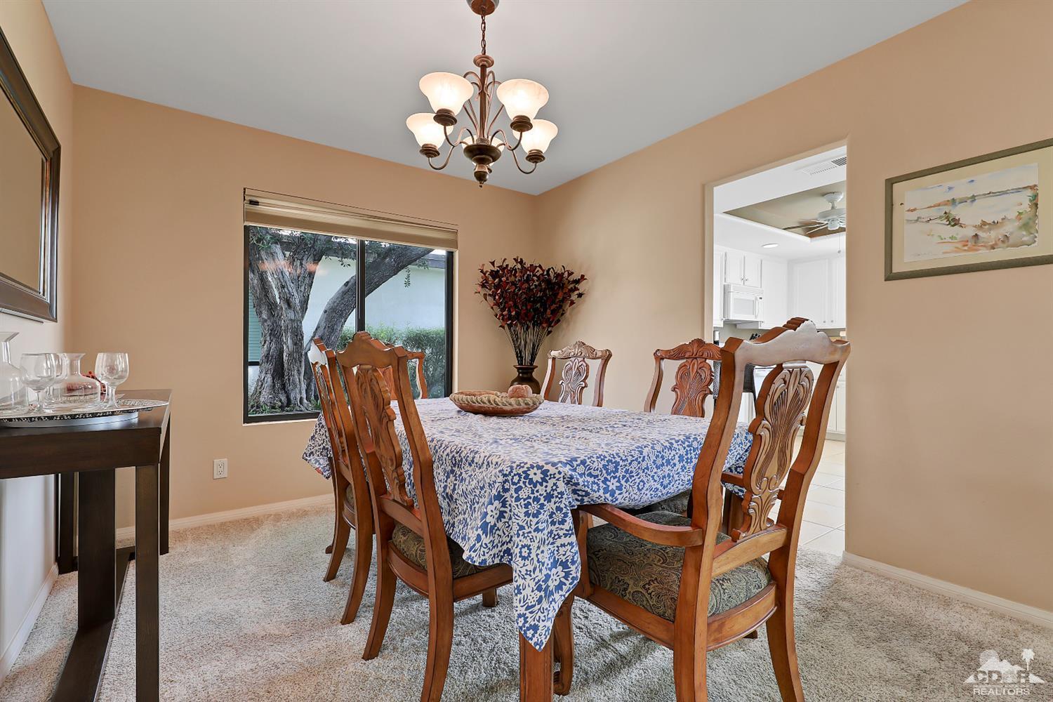 71 Calle Encinitas Rancho Mirage, CA 92270 - Photo 3 of 24 a dining room with furniture a chandelier and wooden floor