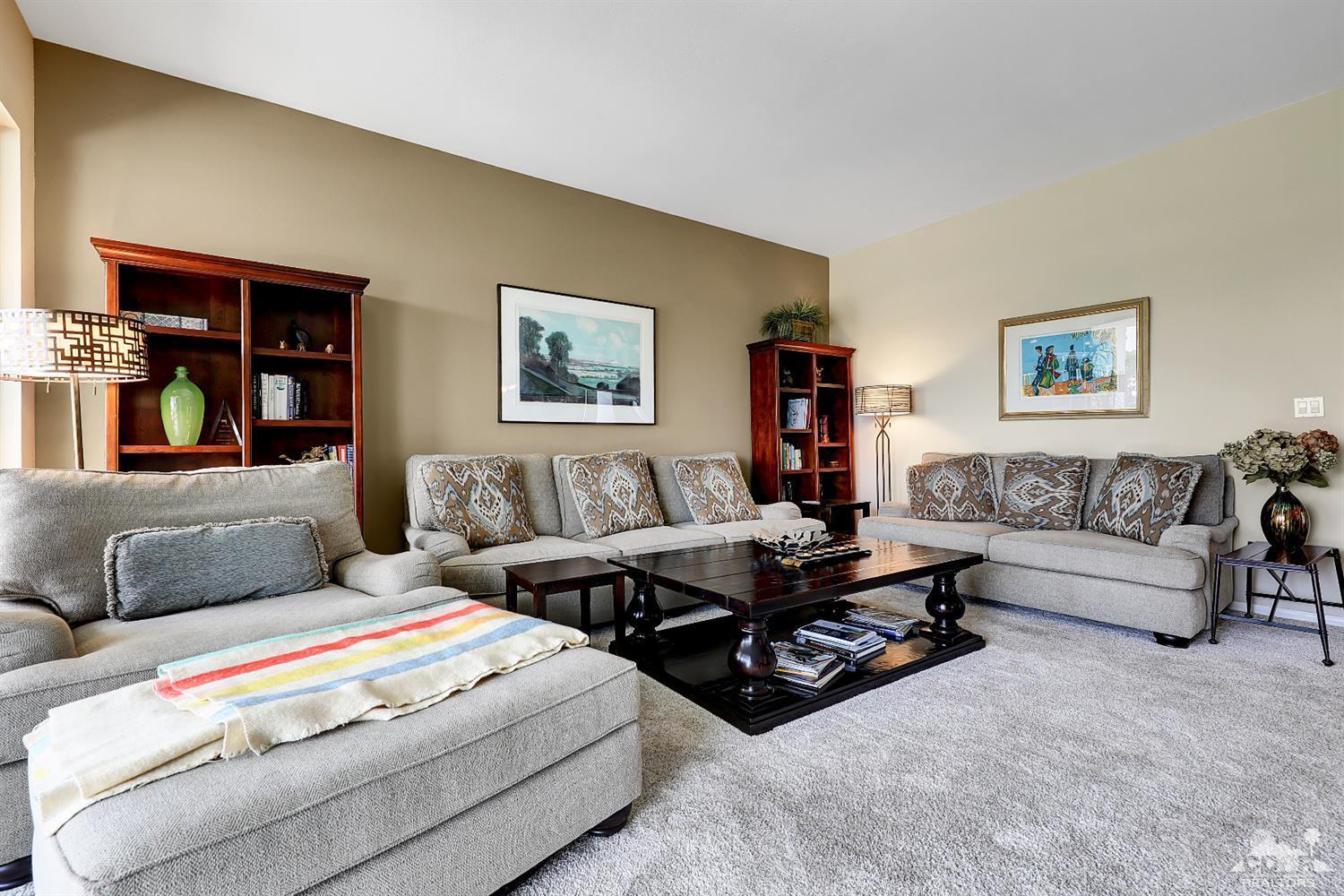 71 Calle Encinitas Rancho Mirage, CA 92270 - Photo 4 of 24 a living room with furniture large window and wall paintings
