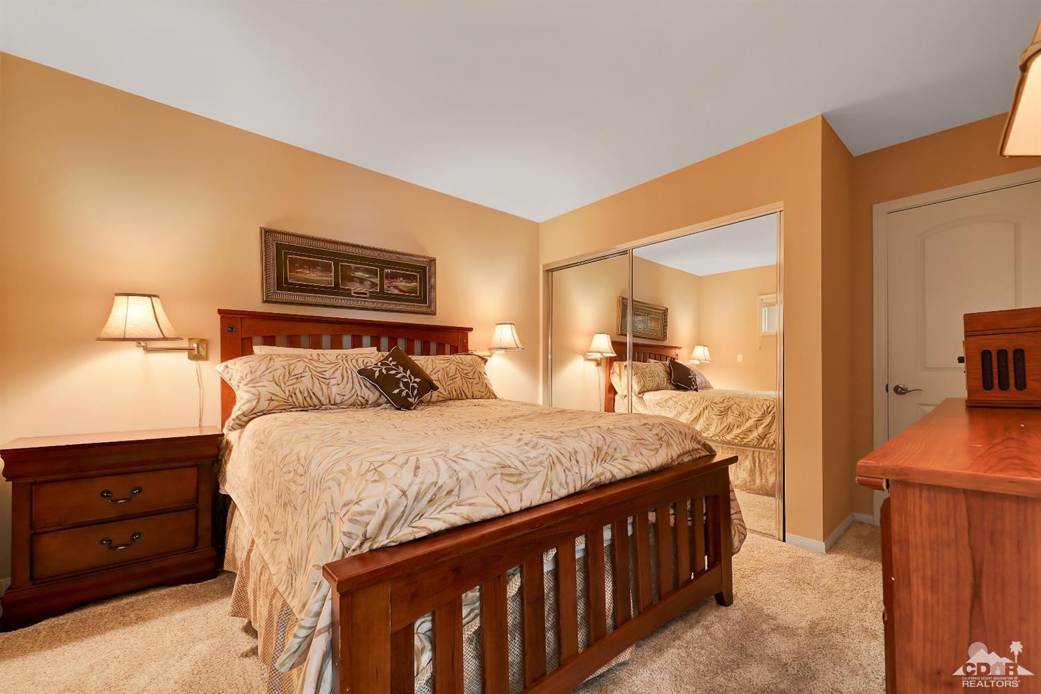 71 Calle Encinitas Rancho Mirage, CA 92270 - Photo 8 of 24 a bedroom with a bed and a dresser