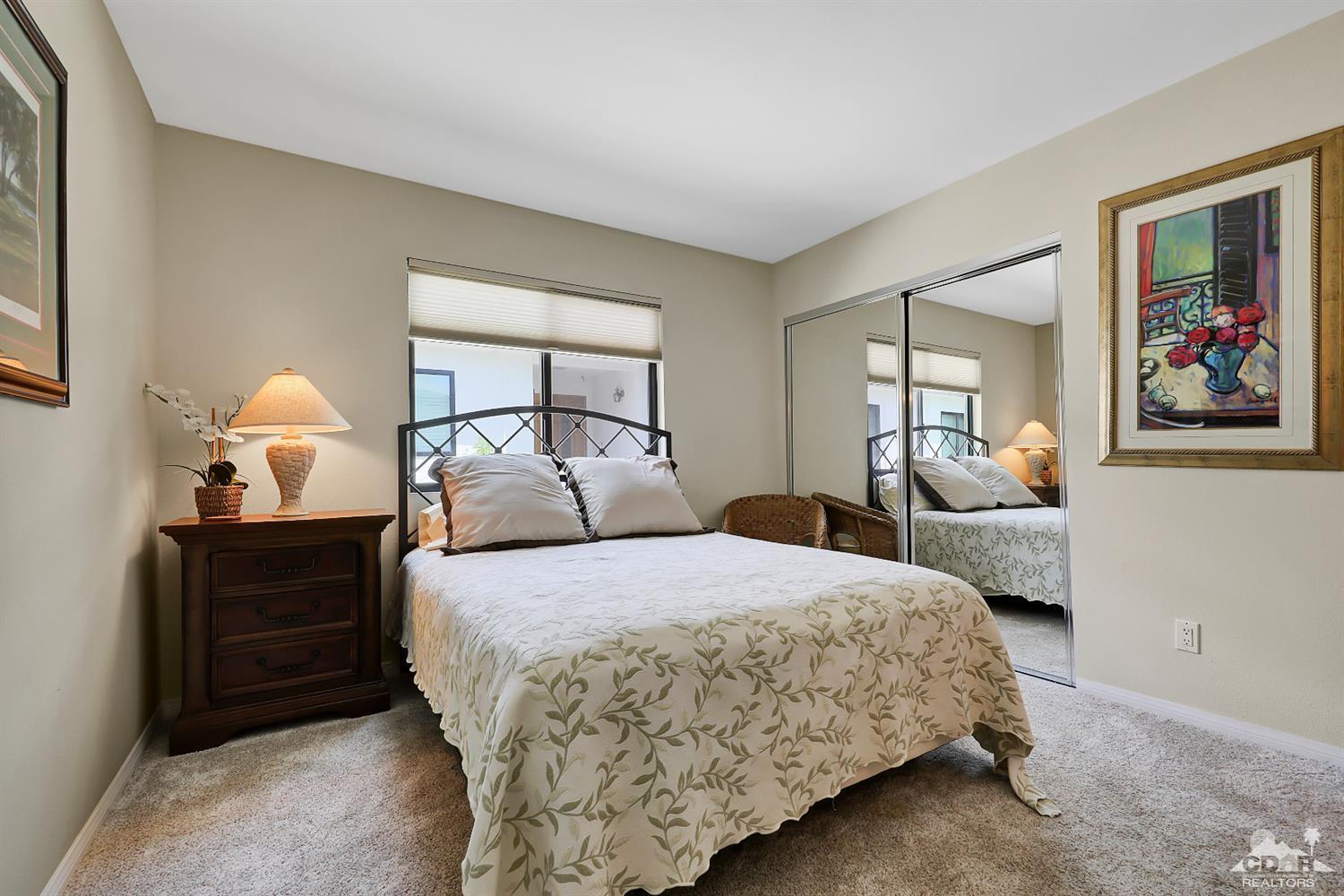 71 Calle Encinitas Rancho Mirage, CA 92270 - Photo 10 of 24 a bedroom with a bed and window