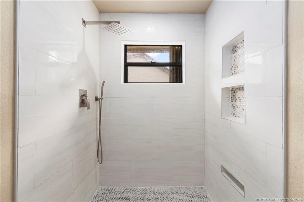3281 Southwest Bobalink Way Palm City, FL 34990 - Photo 16 of 45 Updated primary walk-in shower.