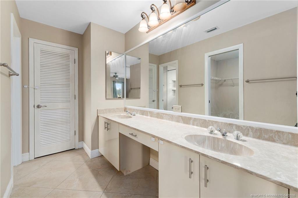3281 Southwest Bobalink Way Palm City, FL 34990 - Photo 17 of 45 Double vanity area with storage.