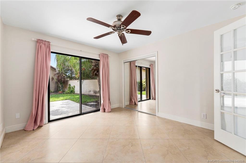 3281 Southwest Bobalink Way Palm City, FL 34990 - Photo 25 of 45 3rd bedroom with slider to side patio.