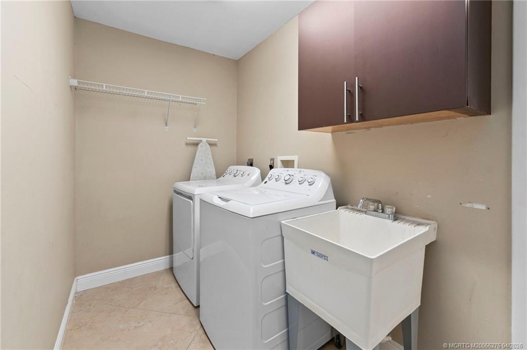 3281 Southwest Bobalink Way Palm City, FL 34990 - Photo 26 of 45 Laundry with sink and storage.