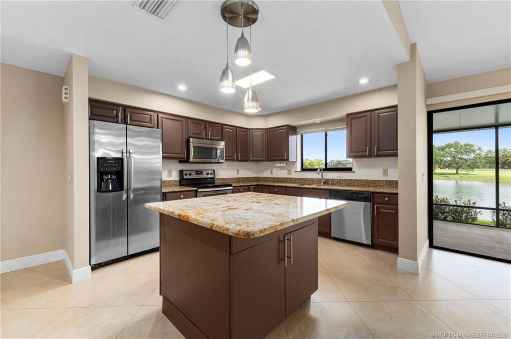 3281 Southwest Bobalink Way Palm City, FL 34990 - Photo 9 of 45 Center island kitchen with granite and S/S appliances.