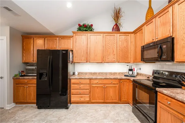 a kitchen with a refrigerator and a sink