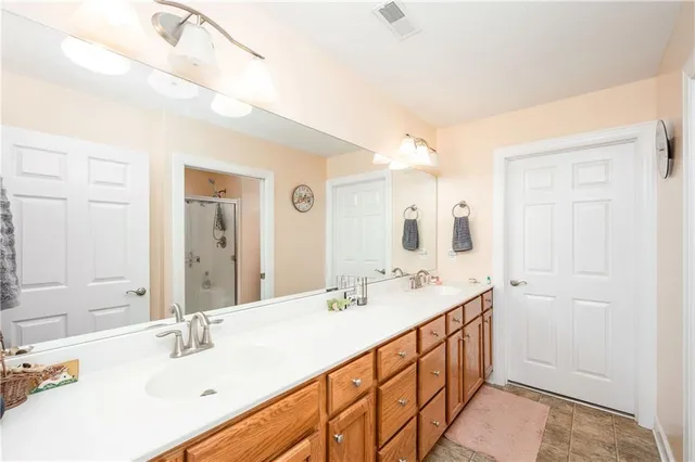 a bathroom with a double vanity sink mirror and