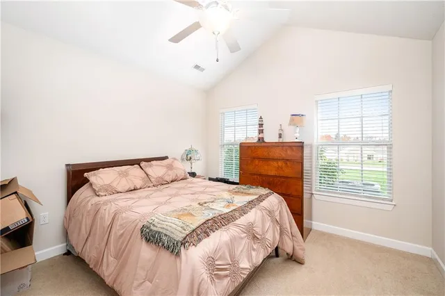 a bedroom with a large bed and a window
