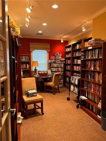 a reading room with furniture and a book shelf