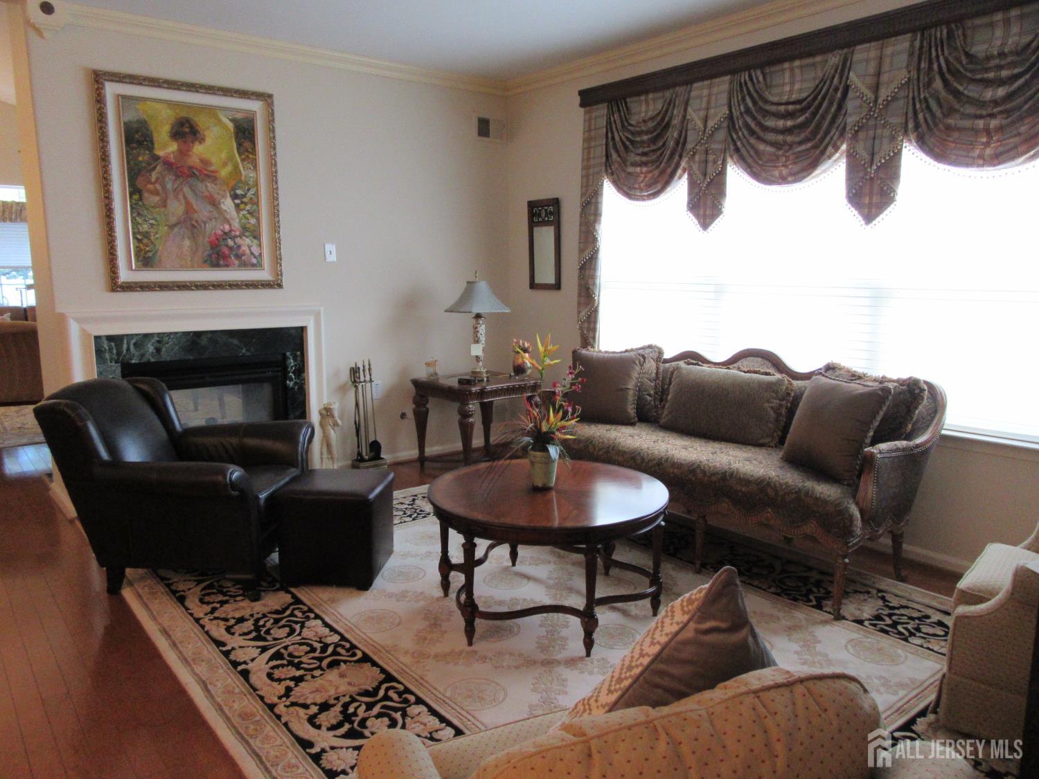 114 Orleans Road Monroe Township, NJ 08831 - Photo 5 of 22 a living room with furniture a table and a fireplace
