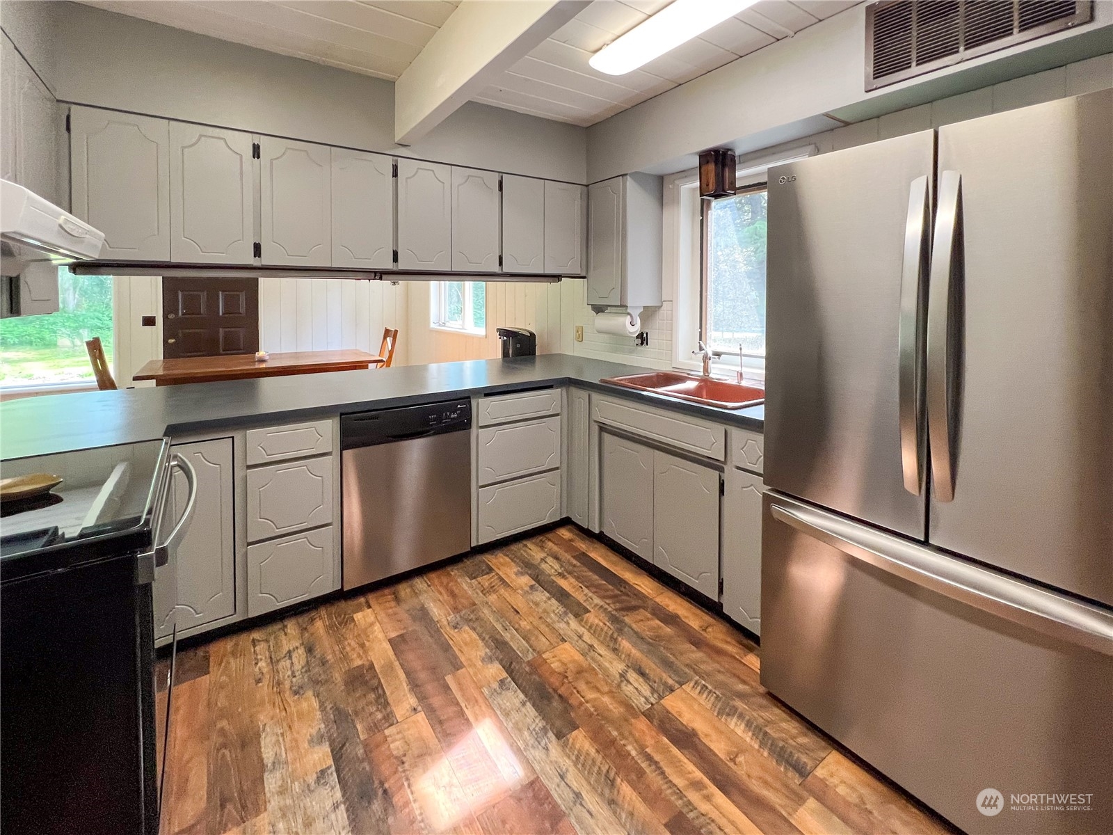 1958 Zell Road Ferndale, WA 98248 - Photo 23 of 28 a kitchen with stainless steel appliances granite countertop a refrigerator sink and cabinets