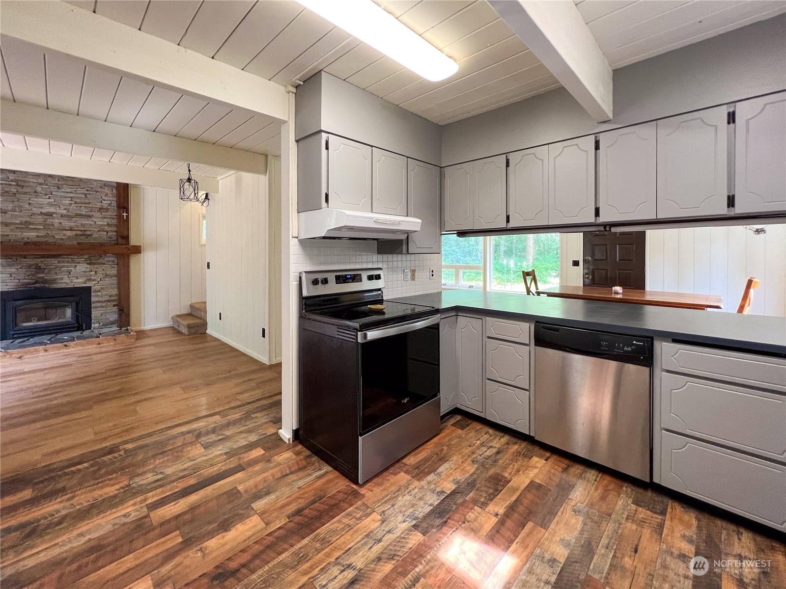 1958 Zell Road Ferndale, WA 98248 - Photo 24 of 28 a kitchen with granite countertop a stove top oven a sink and cabinets