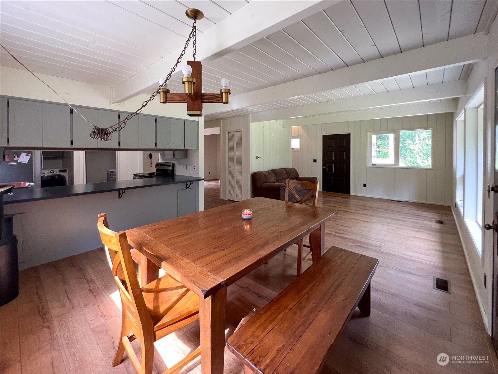 1958 Zell Road Ferndale, WA 98248 - Photo 25 of 28 a dining room with wooden floor a chandelier a wooden table and chairs