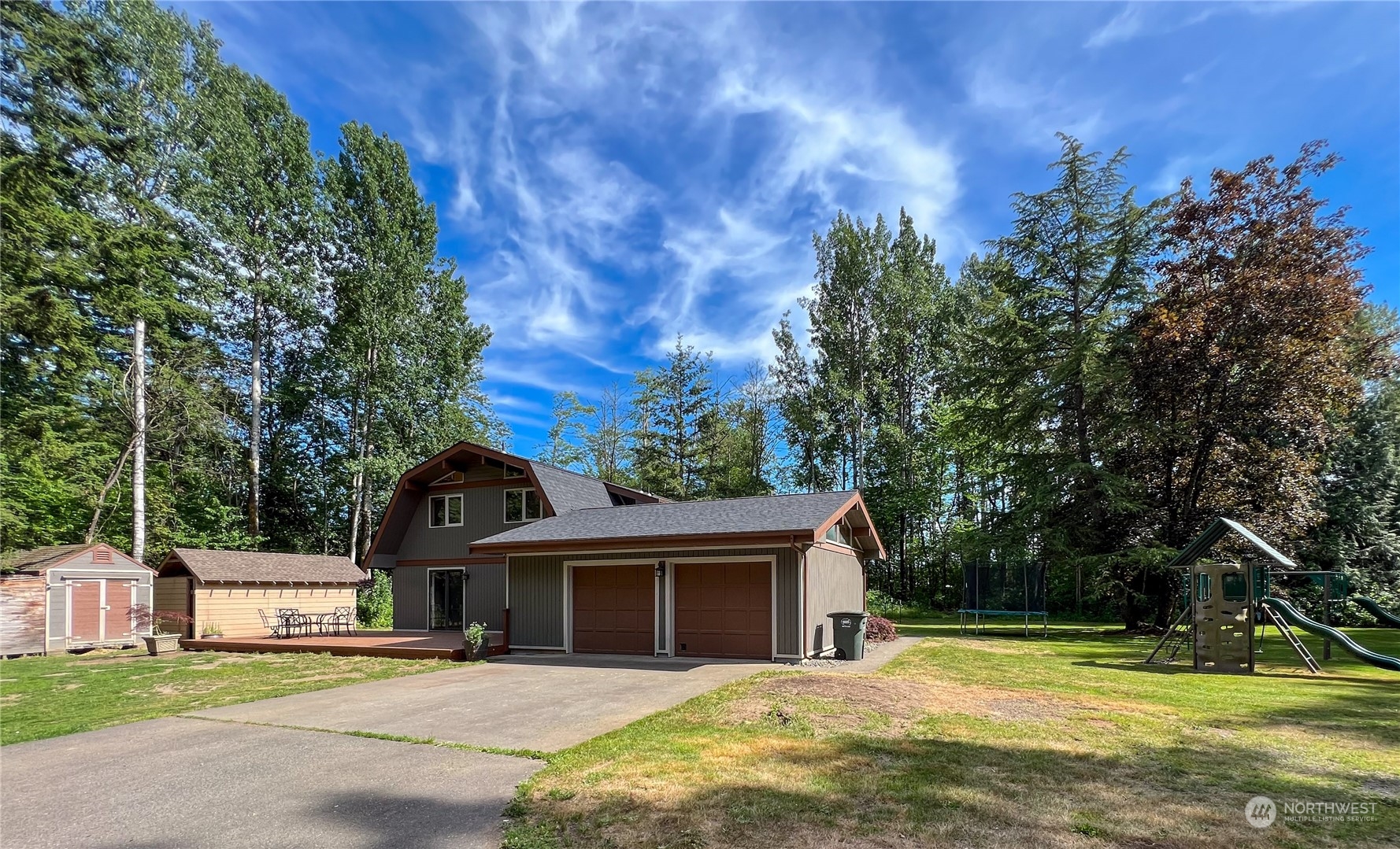 1958 Zell Road Ferndale, WA 98248 - Photo 4 of 28 a front view of a house with a yard garage and outdoor seating