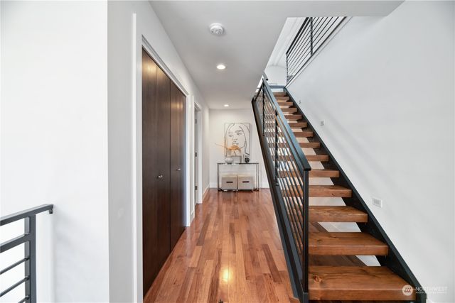 a view of a hallway with wooden floor and entryway