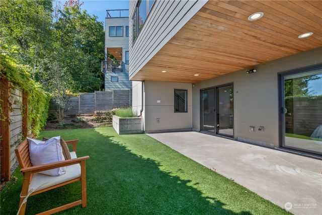 a view of a backyard with sitting area