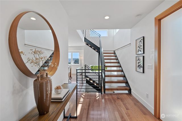 a view of entryway and hall with wooden floor