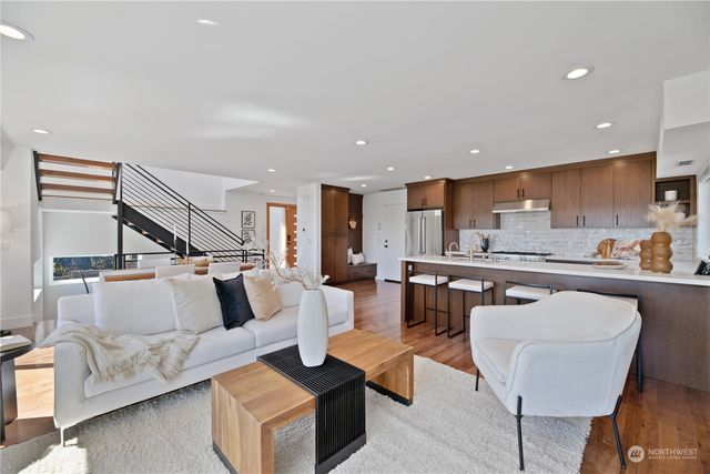 a living room with furniture and kitchen view