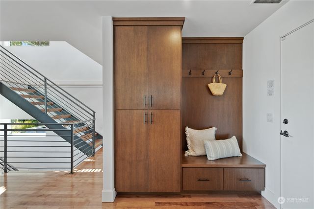 a view of a hallway with wooden floor and staircase