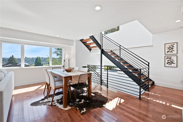 a view of a dining room with furniture window and wooden floor