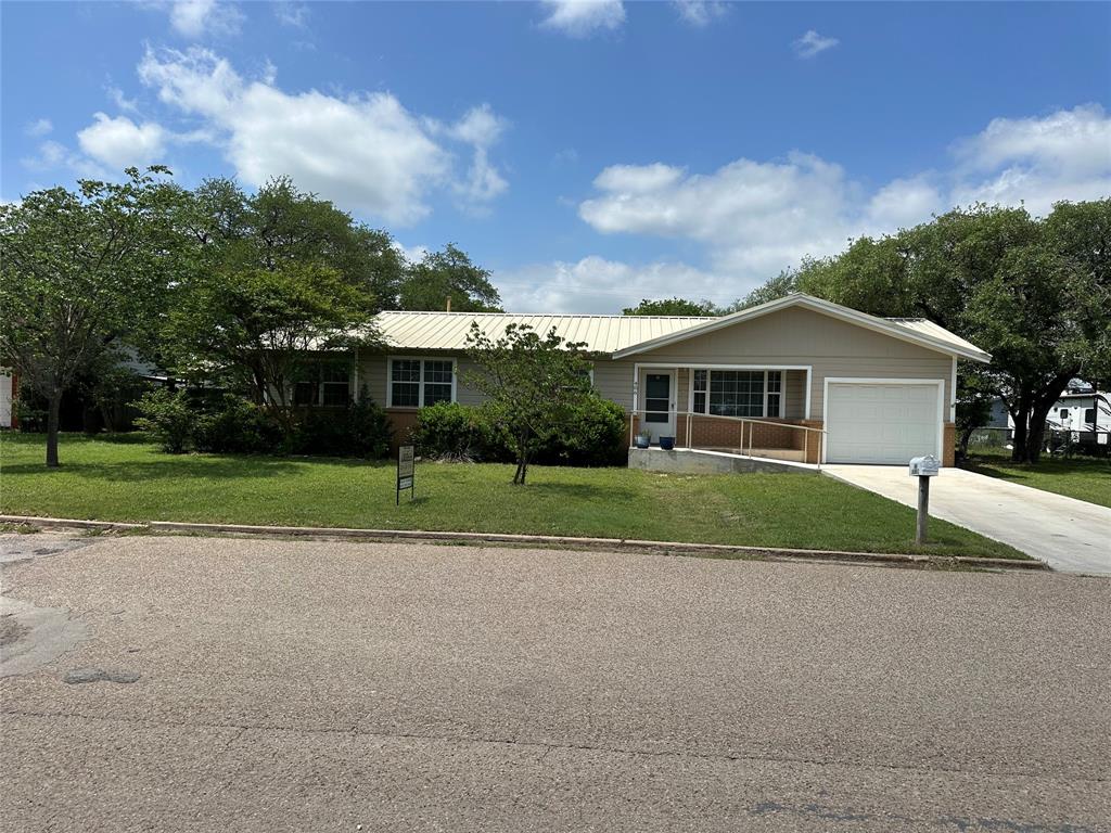 a view of house with yard and green space