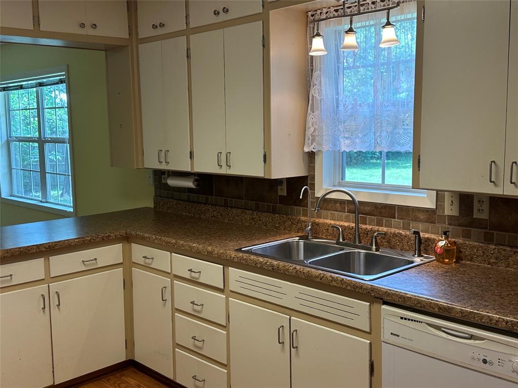406 South Williams Street Hamilton, TX 76531 - Photo 13 of 35 a kitchen with stainless steel appliances white cabinets and a sink