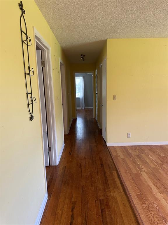 406 South Williams Street Hamilton, TX 76531 - Photo 14 of 35 a view of a hallway with wooden floor
