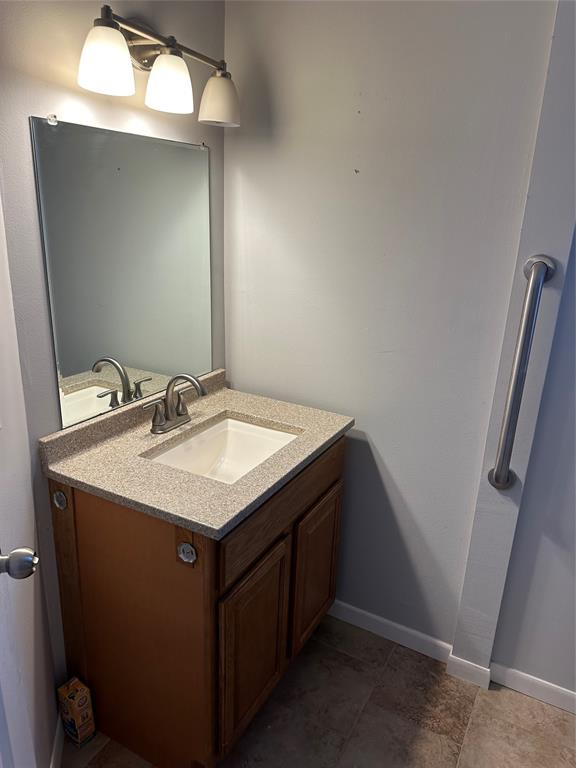 406 South Williams Street Hamilton, TX 76531 - Photo 26 of 35 a utility room with a sink a mirror and vanity