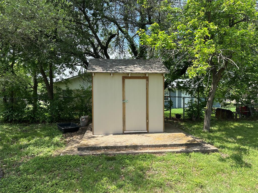 406 South Williams Street Hamilton, TX 76531 - Photo 32 of 35 a view of a wooden house with a yard
