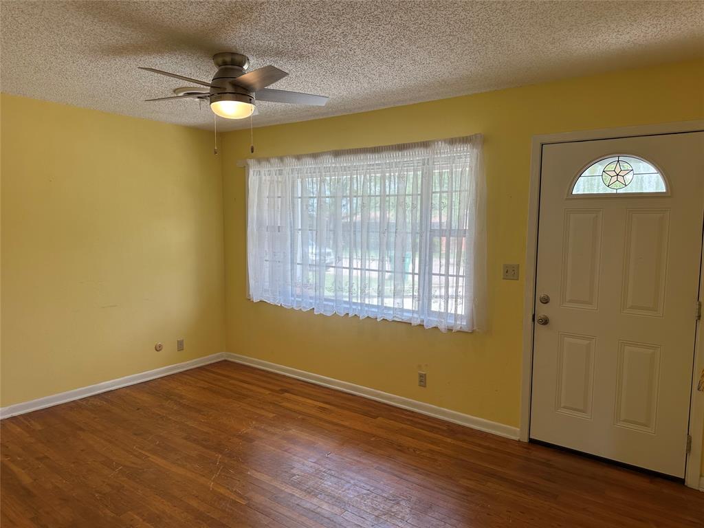 406 South Williams Street Hamilton, TX 76531 - Photo 5 of 35 a view of a livingroom with a window and wooden floor
