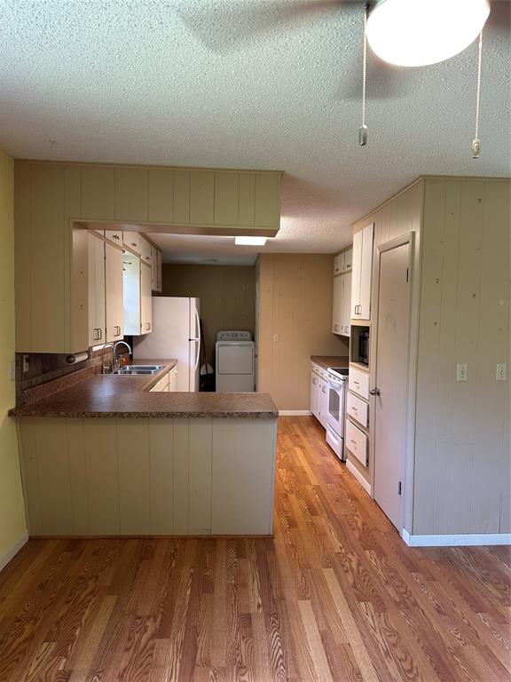 406 South Williams Street Hamilton, TX 76531 - Photo 9 of 35 a kitchen with stainless steel appliances granite countertop a sink and a refrigerator