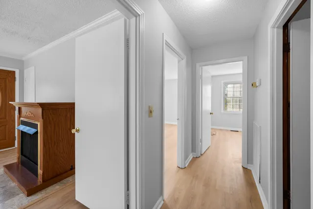a view of a hallway with closet and wooden floor