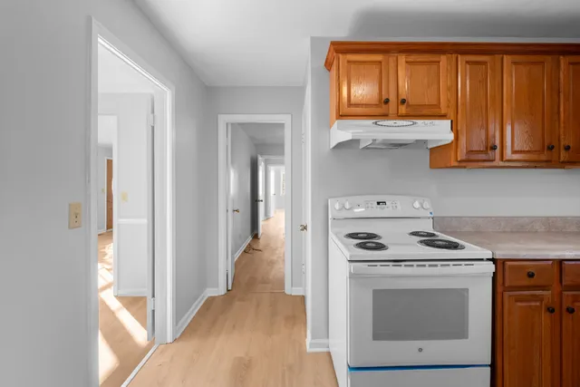 a kitchen with a stove oven and a window