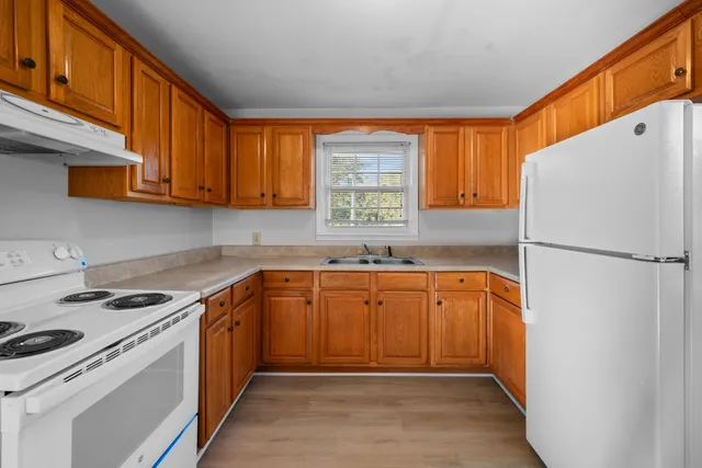 a kitchen with stainless steel appliances granite countertop a refrigerator sink and cabinets