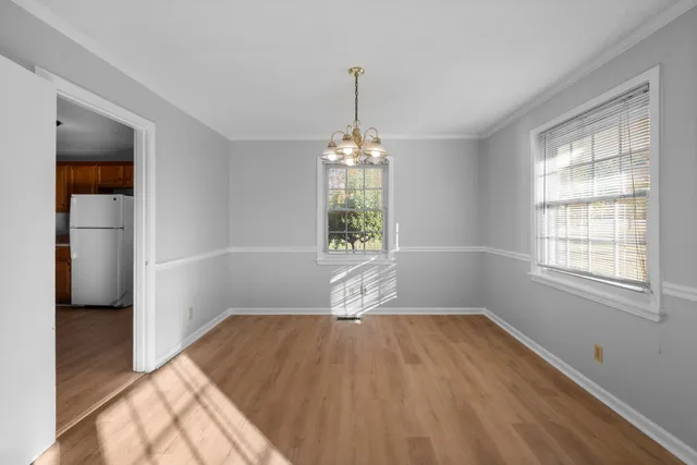 a view of a livingroom with wooden floor and a window
