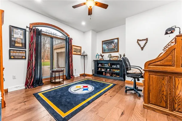 a living room with hard wood floor and furniture