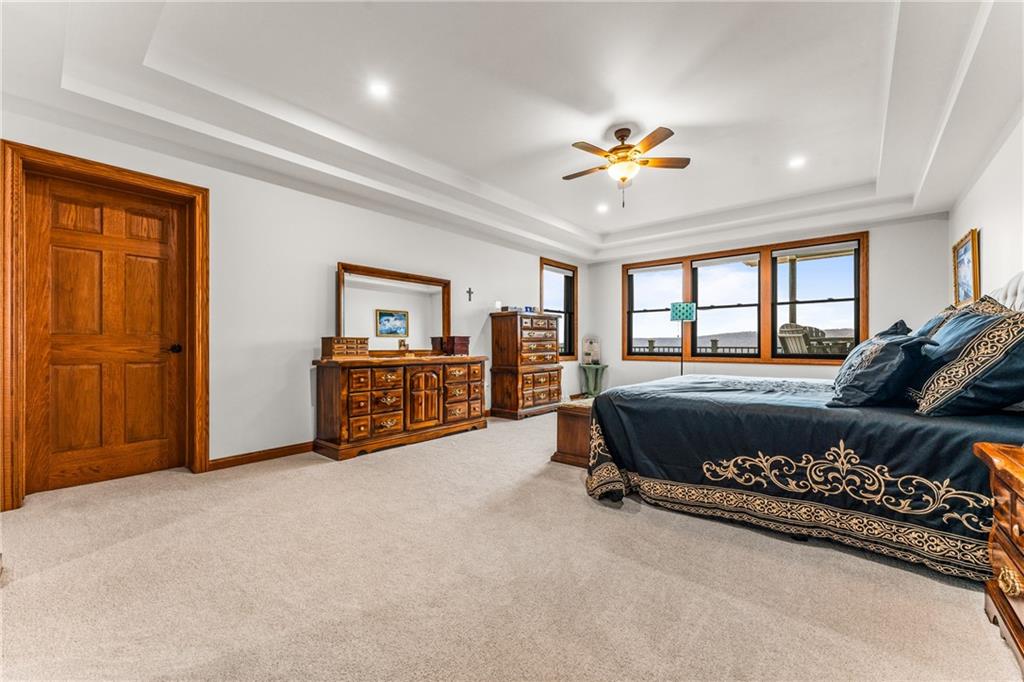 365 South Penn Road Franklin, PA 16323 - Photo 21 of 48 a spacious bedroom with a bed a dresser and a chandelier
