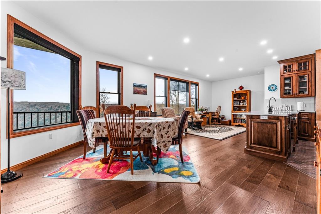 365 South Penn Road Franklin, PA 16323 - Photo 27 of 45 a living room with furniture a dining table wooden floor and a floor to ceiling window